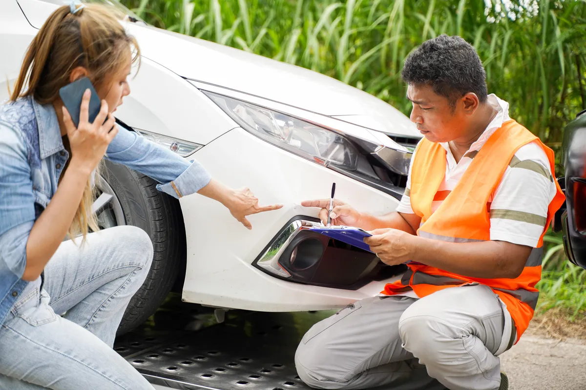 Adjuster speaks with a driver after an accident