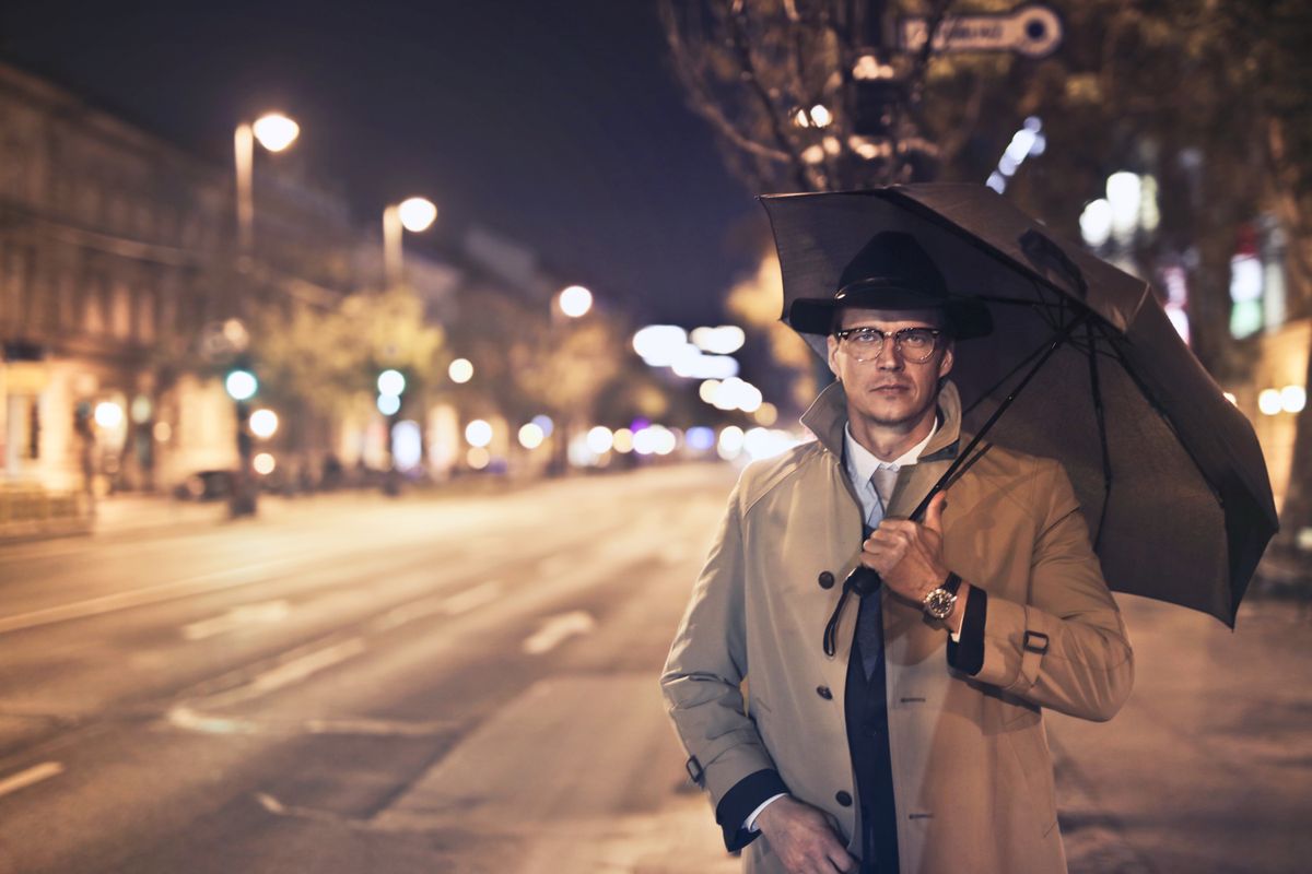 Professional under an umbrella labeled Umbrella Insurance