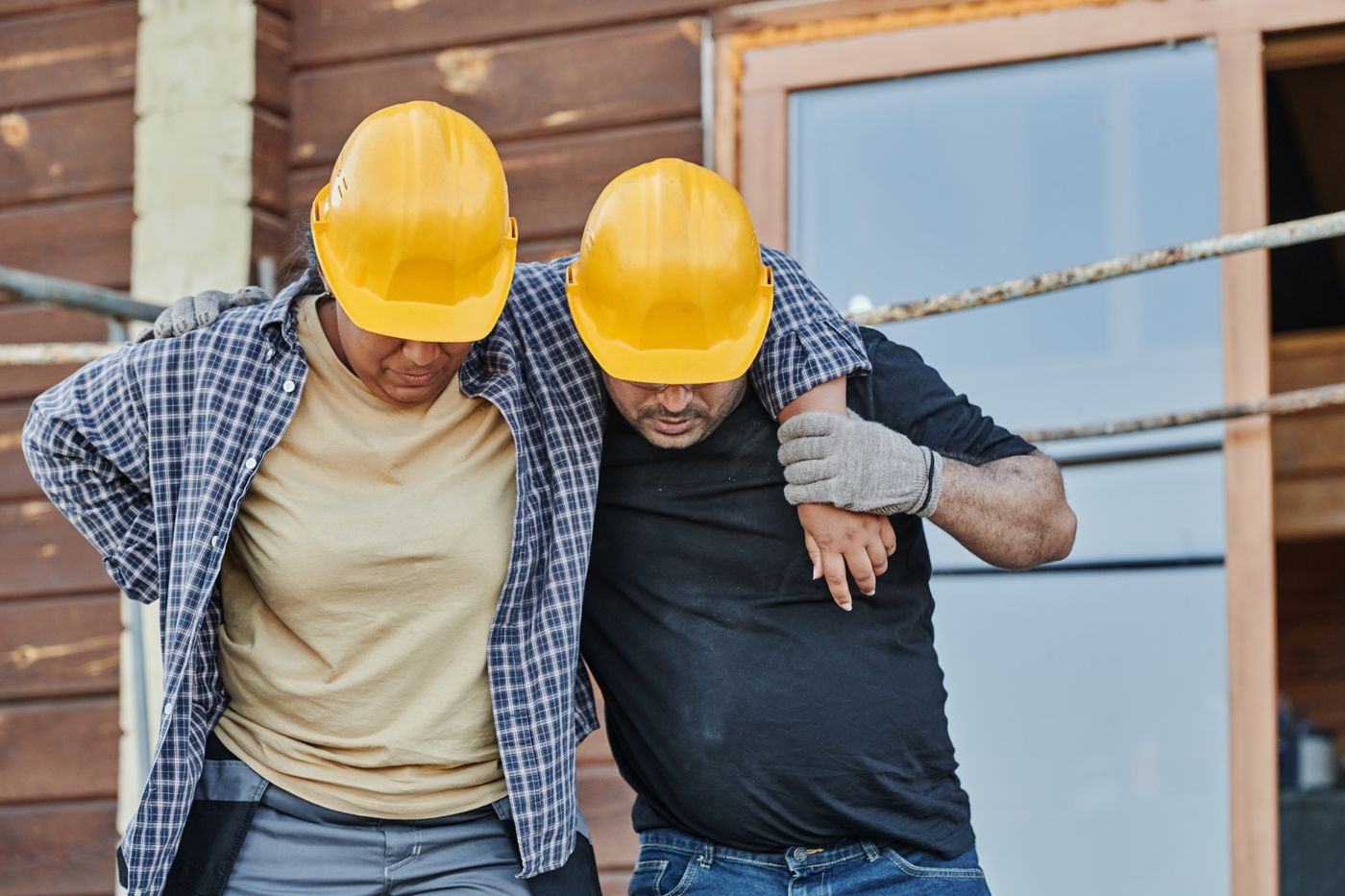 Workers help an injured coworker